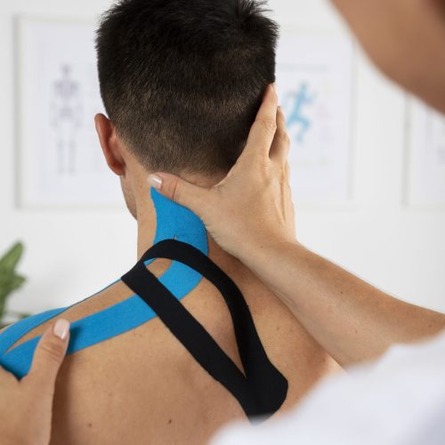 female-physiotherapist-applying-elastic-medical-bandage-male-patient